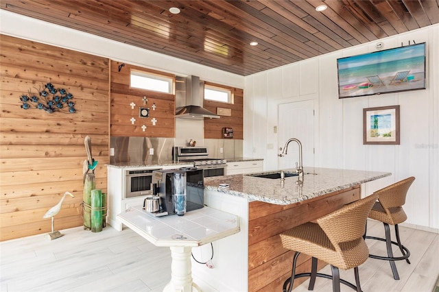 kitchen featuring ventilation hood, appliances with stainless steel finishes, wooden ceiling, light stone countertops, and sink