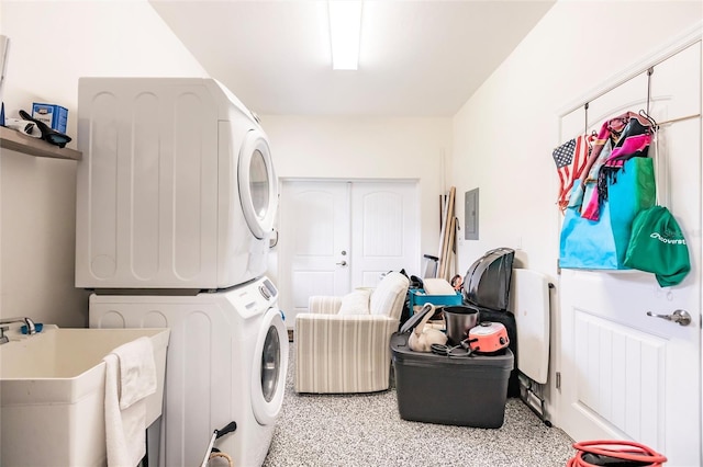 washroom featuring electric panel, stacked washer / dryer, and sink