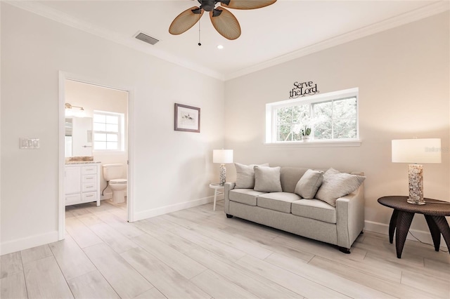 living room with ceiling fan, ornamental molding, and light hardwood / wood-style flooring