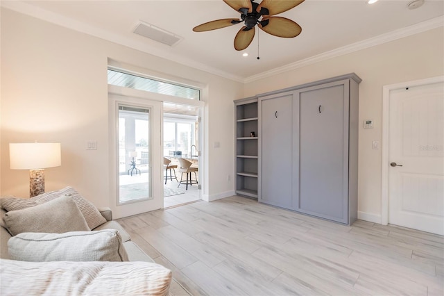 sitting room with ceiling fan, light hardwood / wood-style flooring, crown molding, and french doors