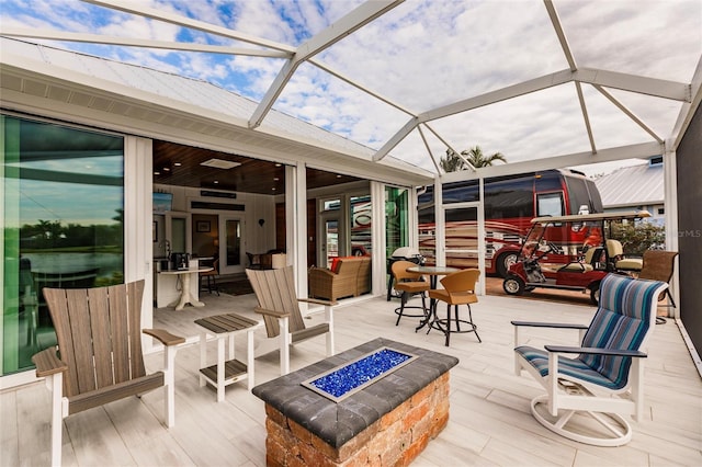 view of patio / terrace featuring a lanai and an outdoor fire pit