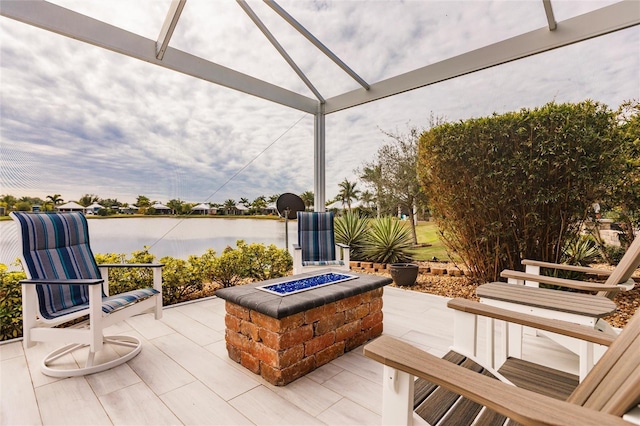 view of patio featuring a water view and a fire pit