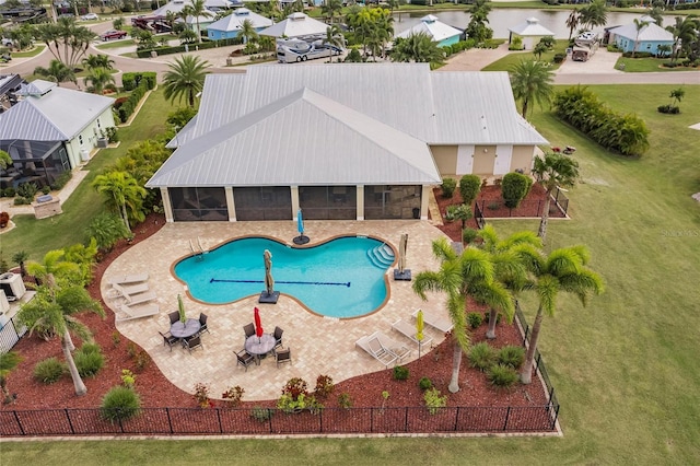 view of pool featuring a patio and a sunroom