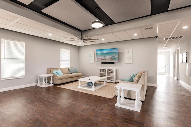 living room with ceiling fan and dark hardwood / wood-style floors