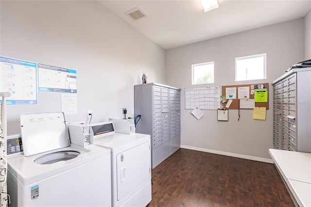 clothes washing area with dark wood-type flooring and washing machine and dryer