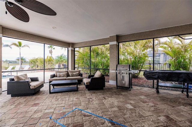 sunroom / solarium featuring ceiling fan