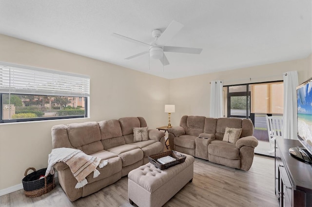 living room with ceiling fan and light hardwood / wood-style flooring