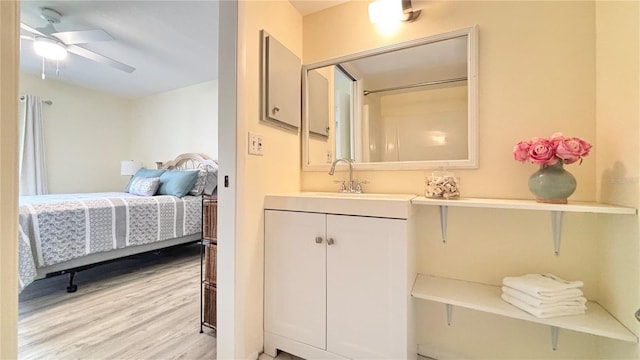 bathroom featuring ceiling fan, hardwood / wood-style flooring, and vanity