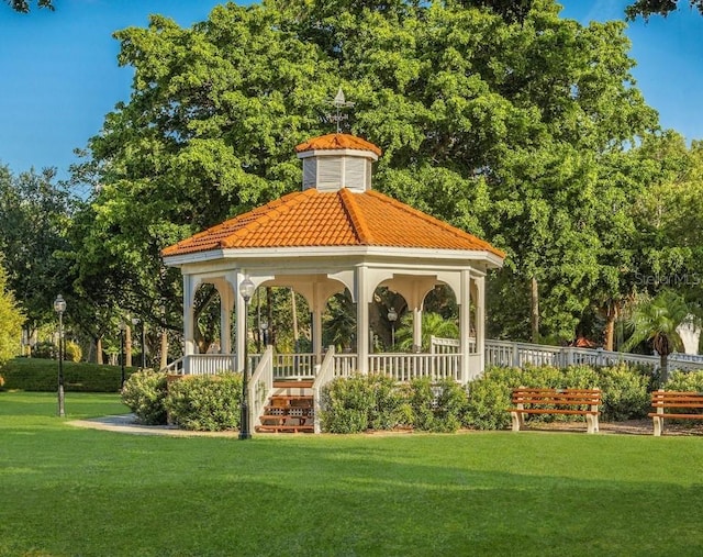 surrounding community with a gazebo and a yard