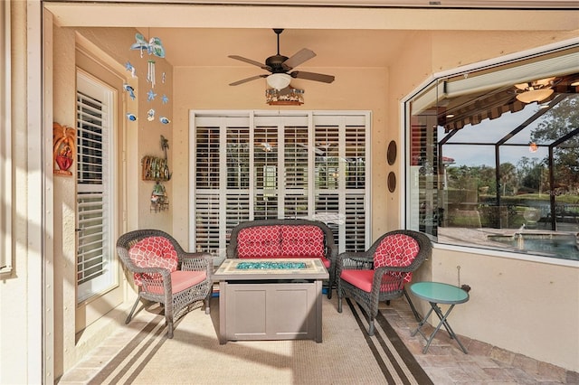 view of patio / terrace with ceiling fan and a fire pit