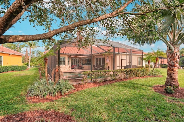 back of house with a lanai, a lawn, and a pool