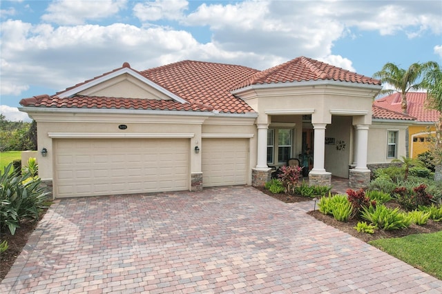 mediterranean / spanish home with a garage