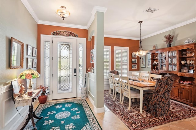 tiled foyer entrance with ornamental molding