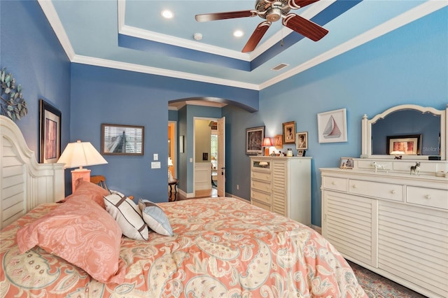 bedroom featuring ceiling fan, crown molding, and a raised ceiling