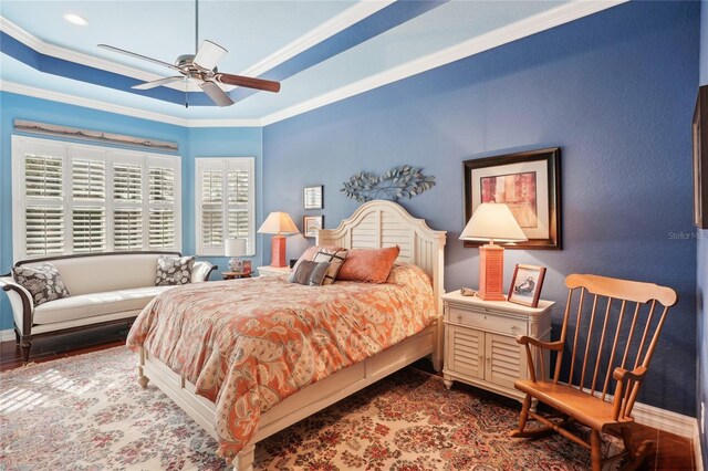 bedroom featuring ceiling fan and ornamental molding