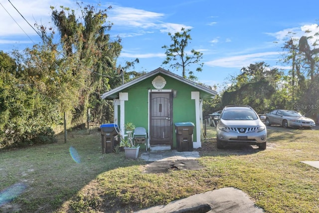 view of outbuilding featuring a yard