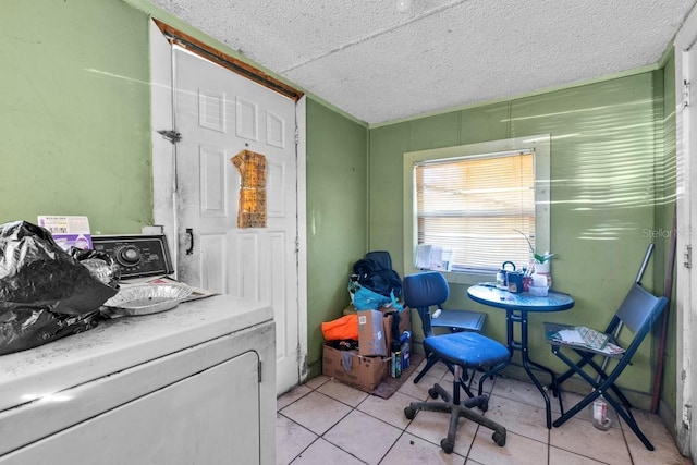 washroom featuring washer / dryer and light tile patterned flooring