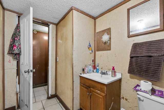 bathroom with toilet, vanity, and tile patterned floors