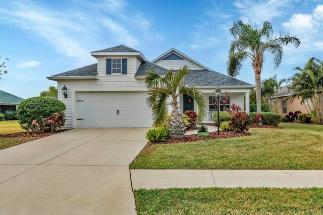 view of front of home with a front yard and a garage