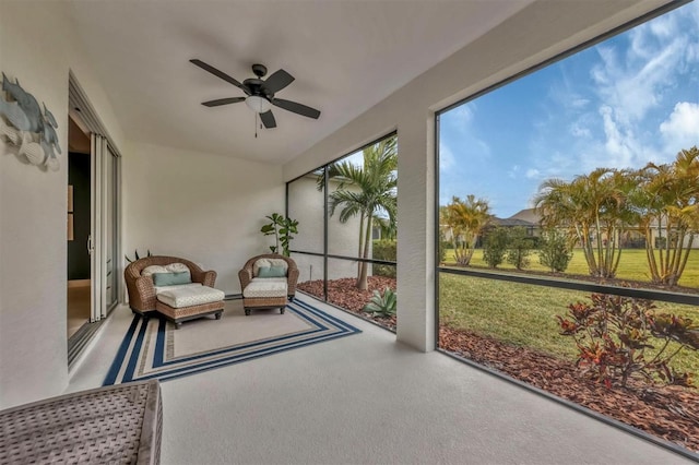 sunroom featuring ceiling fan