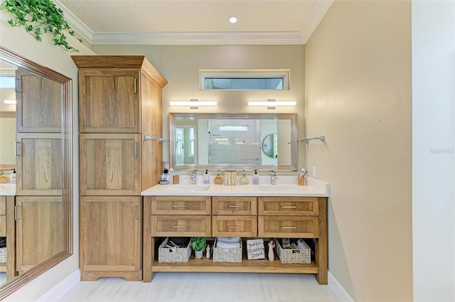 bathroom with tile patterned floors, crown molding, walk in shower, and vanity