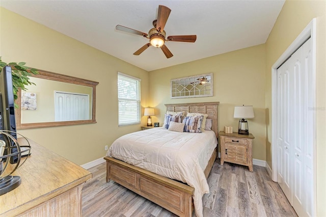 bedroom featuring ceiling fan, light wood-type flooring, and a closet