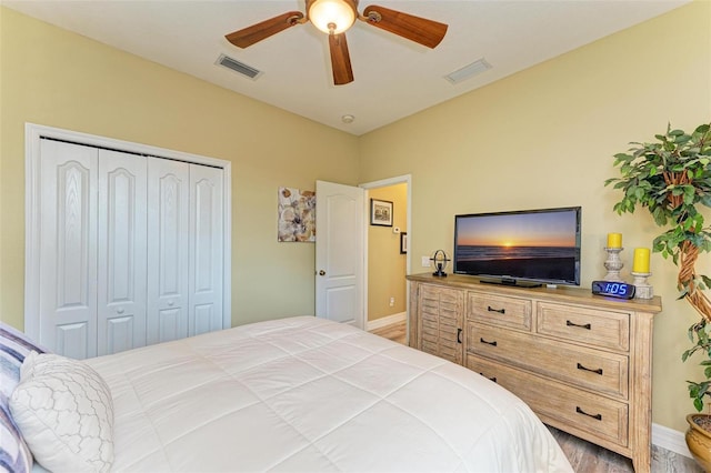 bedroom featuring ceiling fan, a closet, and hardwood / wood-style floors