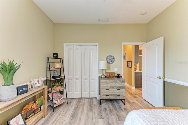 bedroom with a closet and light hardwood / wood-style floors