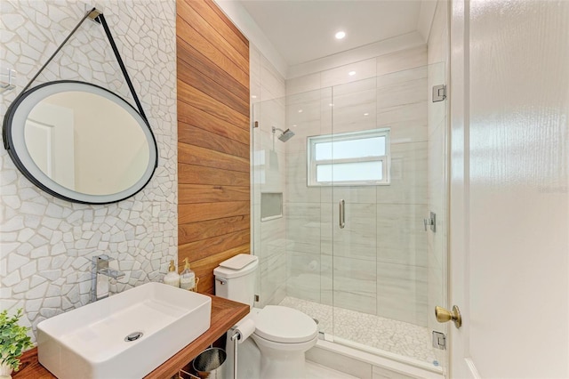 bathroom featuring sink, toilet, walk in shower, and wooden walls