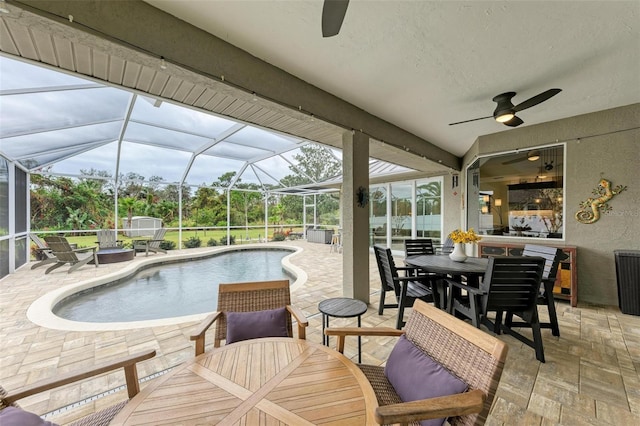 view of pool featuring glass enclosure and a patio area