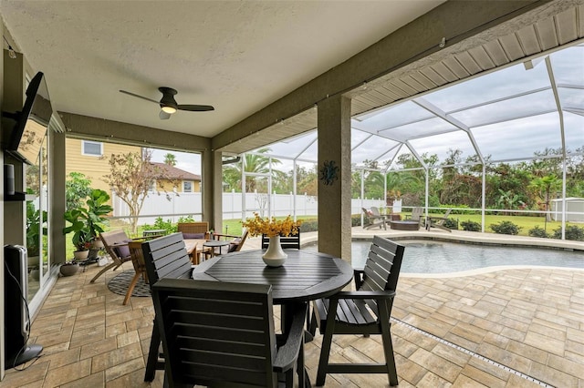 sunroom / solarium with ceiling fan and a pool