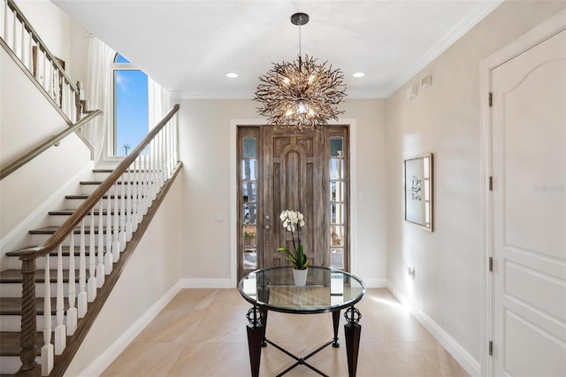 tiled foyer featuring ornamental molding and a chandelier