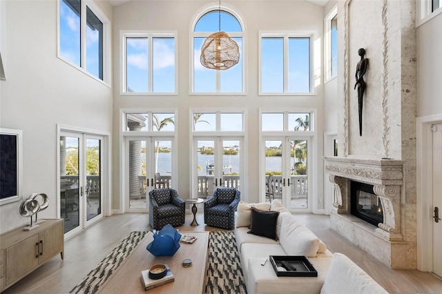 living room with a towering ceiling and french doors