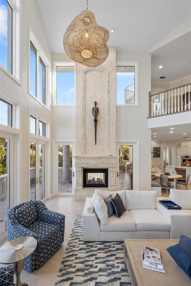 living room featuring a high ceiling and a premium fireplace