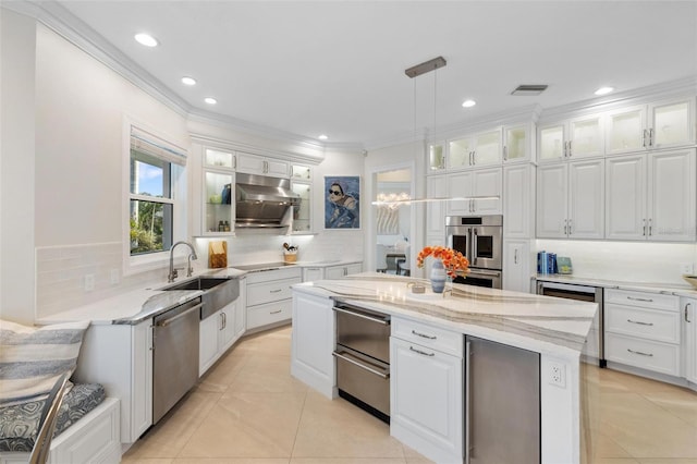 kitchen featuring pendant lighting, sink, and white cabinetry