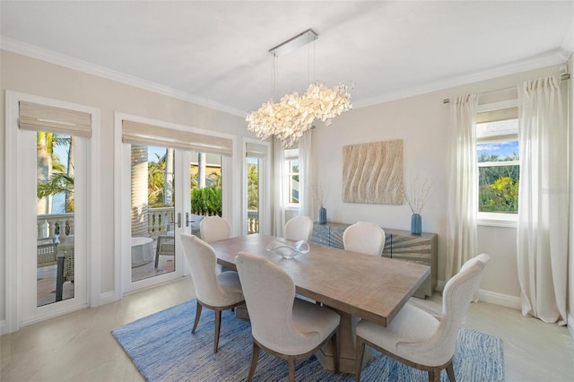 dining area with an inviting chandelier and ornamental molding