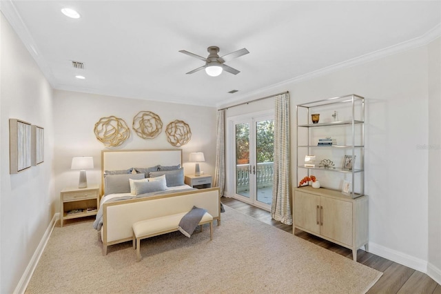 bedroom with ceiling fan, access to outside, french doors, wood-type flooring, and crown molding