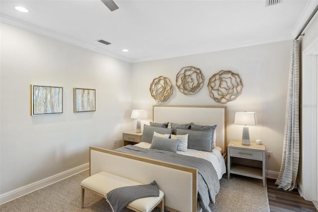 bedroom featuring ceiling fan, ornamental molding, and hardwood / wood-style floors