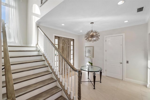 stairs with ornamental molding, tile patterned floors, and a notable chandelier