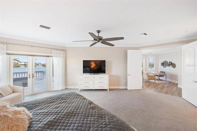 bedroom with ceiling fan, access to exterior, a water view, and carpet flooring