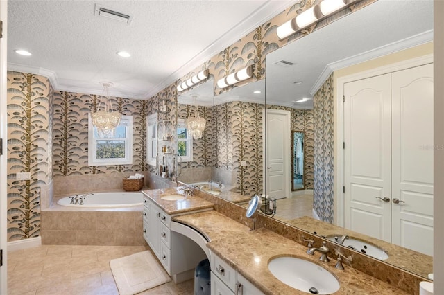 bathroom featuring tiled bath, vanity, tile patterned floors, ornamental molding, and a textured ceiling