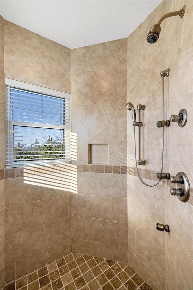 bathroom with tiled shower