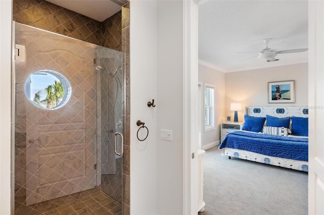 bathroom with ceiling fan, crown molding, and a shower with door