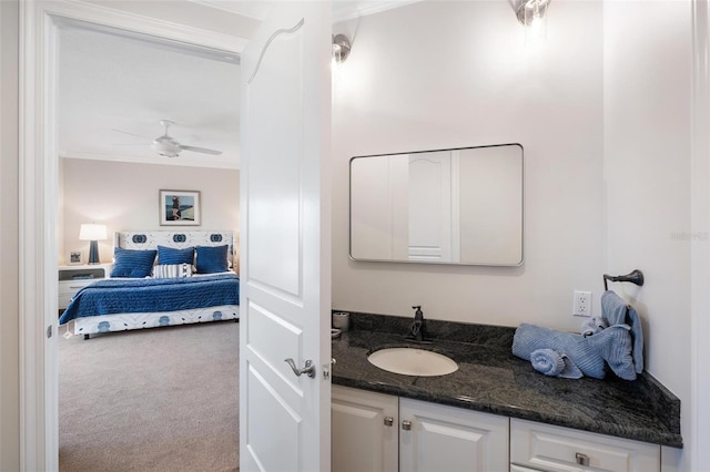 bathroom with ceiling fan, vanity, and ornamental molding