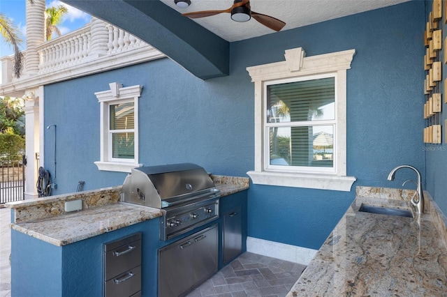 view of patio / terrace featuring ceiling fan, sink, and area for grilling