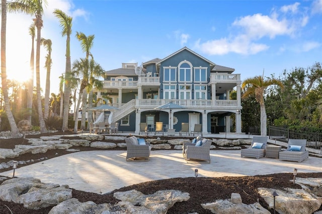 back of property featuring a balcony and a patio area