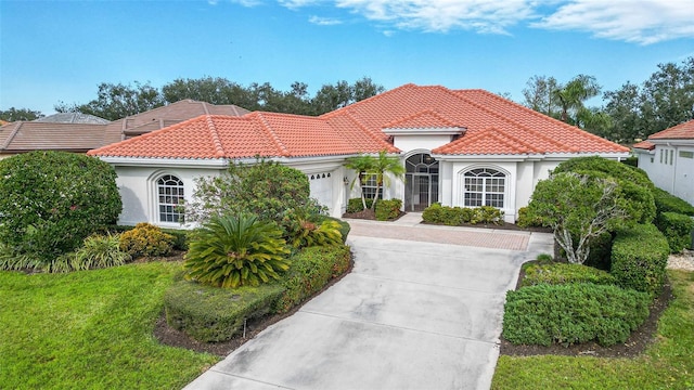 mediterranean / spanish-style house with a garage