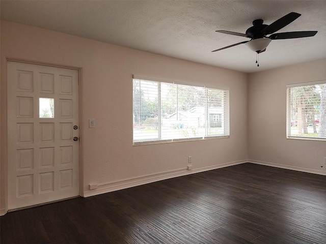 foyer featuring ceiling fan, a textured ceiling, and dark hardwood / wood-style flooring