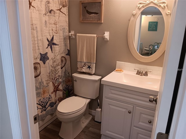 bathroom featuring toilet, a shower with shower curtain, wood-type flooring, and vanity