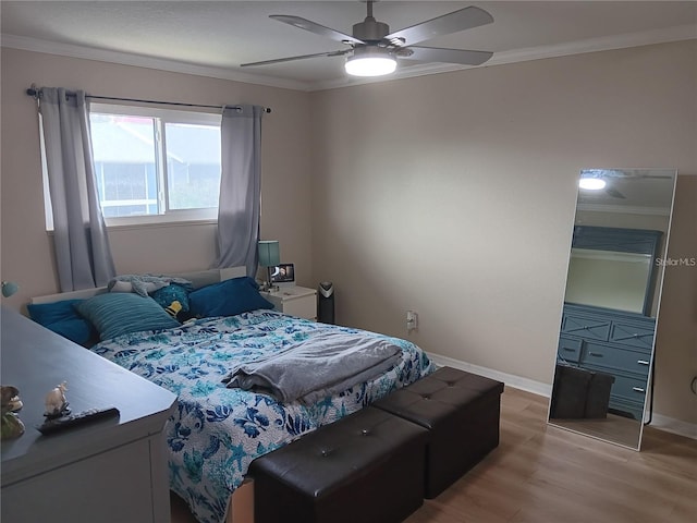 bedroom with ceiling fan, light hardwood / wood-style floors, and crown molding